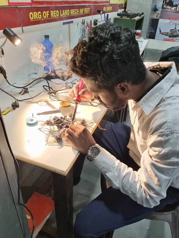 Joy Jackson soldering in lab